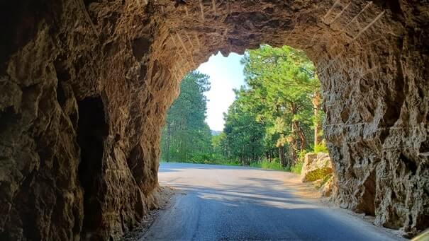Driving through cc gideon tunnel. iron mountain road tunnel. black hills national forest. south dakota travel blog