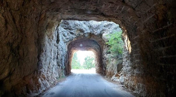Driving through cc gideon tunnel. iron mountain road tunnel. black hills national forest. south dakota travel blog