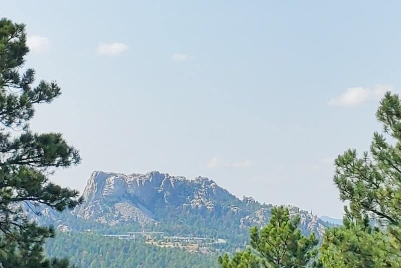 Driving with mount rushmore views on iron mountain road away from scovel johnson tunnel. south dakota travel blog.