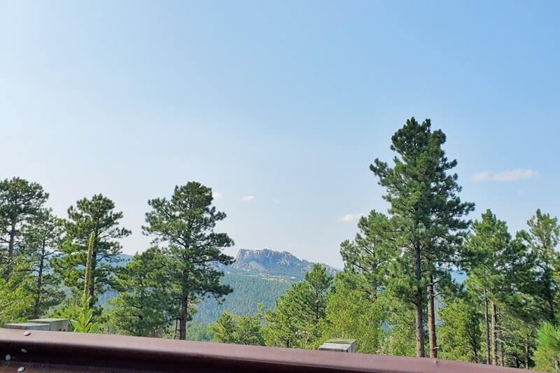 Driving with mount rushmore views on iron mountain road away from scovel johnson tunnel. south dakota travel blog.
