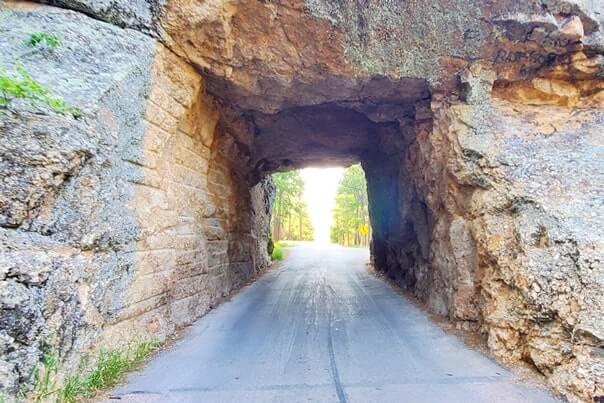 Driving through scovel johnson tunnel. iron mountain road tunnel. black hills national forest. south dakota travel blog