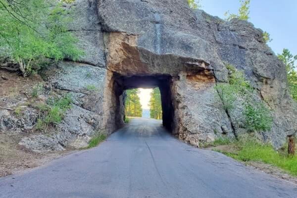 Scovel Johnson Tunnel view of Mount Rushmore on Iron Mountain Road. Driving through Iron Mountain Road tunnel to see Mount Rushmore. black hills national forest. south dakota travel blog
