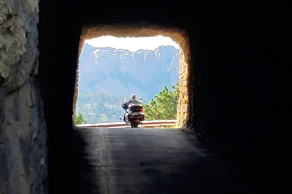 Driving Iron Mountain Road tunnels for tunnel view of Mount Rushmore. Best direction to drive Iron Mountain Road through Black Hills National Forest. south dakota travel blog