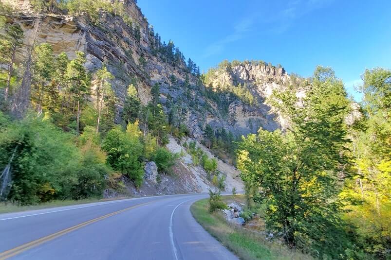 driving the spearfish canyon scenic byway away from bridal veil falls in black hills national forest. south dakota